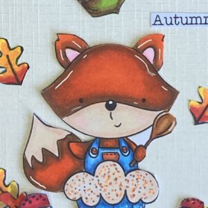 Close up piture digital stamp with autumn sentiment Close-up of the 'Cupcake Fox Autumn' digital stamp and the word 'Autumn' on a fall birthday card. The word 'Autumn' is written in decorative script, framed by fall-themed elements like leaves