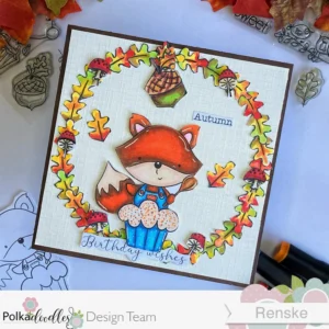 October Birthday card Cupcake Autumn Fox Polkadoodles 3 Fall birthday card displayed at an angle, showcasing the 'Cupcake Fox Autumn' digital stamp. The card features a fox holding a cupcake, surrounded by colorful autumn leaves. The sentiment 'Birthday Wishes' completes this autumn-themed handmade card design."