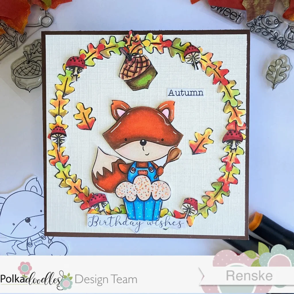 Fall birthday card featuring the 'Cupcake Fox Autumn' digital stamp, viewed from above. The handmade card shows a fox holding a cupcake, surrounded by autumn leaves in shades of orange, yellow, and brown. The sentiment 'Birthday Wishes' is placed at the bottom, perfect for a seasonal birthday card.