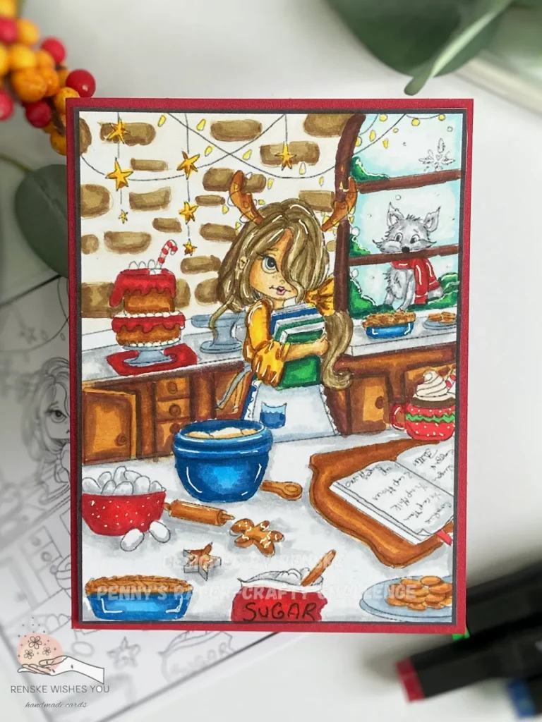 Top-down view of a handmade Christmas card lying flat, featuring the 'Rory Bake Time' digital stamp from Colour of Love. The card is decorated with a scene of a woman in a kitchen with holiday-themed decor and surrounded by craft materials like leaves, berries, and a alcohol markers.. This card design allows you to colour your own Christmas card.