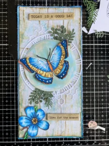 All the layers on the background of the butterfly greering card Layered card background showing wood texture, blue border, and textured die-cut elements for a vintage butterfly greeting card.