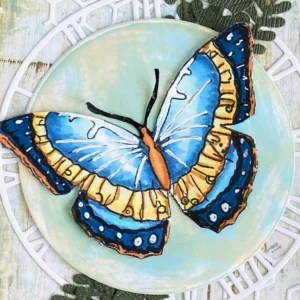 Close up picture of the coloured butterfly Close-up of a vibrantly colored butterfly with blue and yellow colours on the vintage butterfly greeting card, with detailed shading and highlights