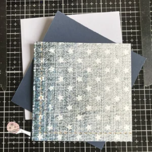 Paper used for the background of our Football-themed cards "Image of the card base for a football-themed card, featuring a blue first layer and patterned paper with white stars, setting the stage for a creative design.