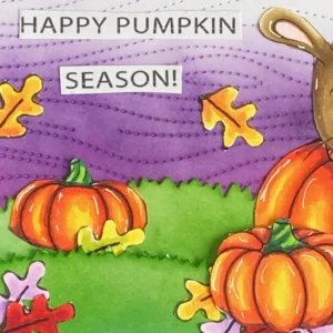 Close up picture of the left side of the card with the pumpkins and sentiment happy pumpkin season Left-side close-up showing the DIY Pumpkin Card's layered look, including pumpkins, autumn leaves, and the sentiment text. The layers and colours add depth and warmth to the design.