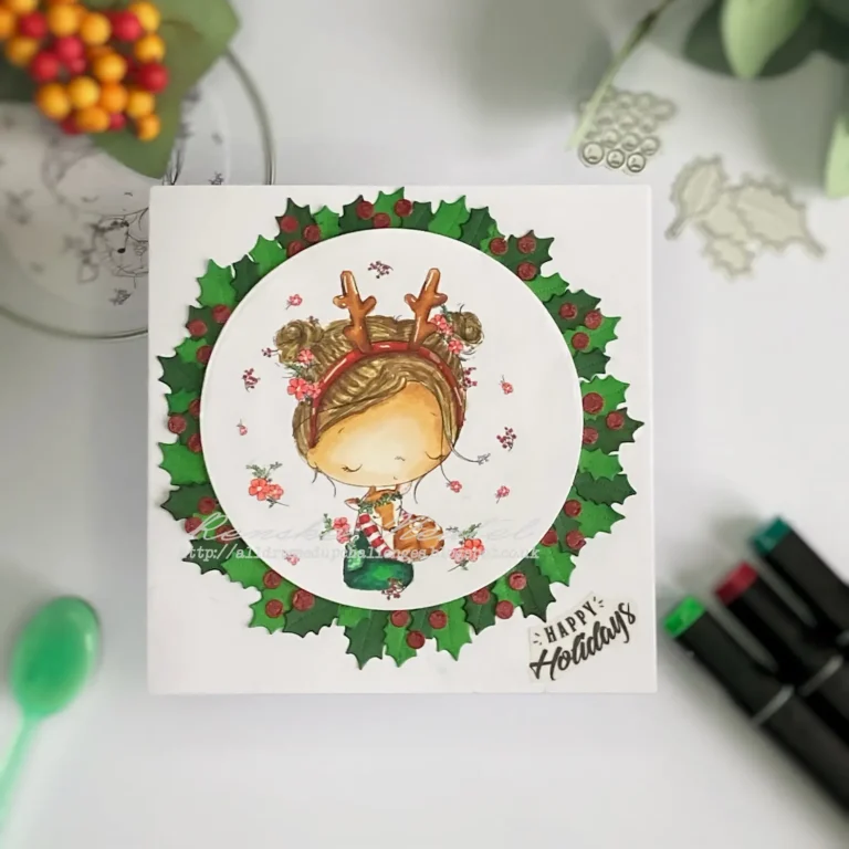 A flat view of the DIY Christmas card wreath featuring the Christmas Hugs digital stamp from All Dressed Up Stamps. The card showcases a girl hugging a deer surrounded by a wreath of holly and berries. The wreath is centered on the card with the 'Happy Holiday' sentiment placed near the bottom-right corner. The card is mounted on a white card base.