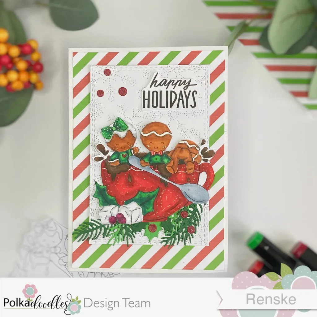 A flat-lay view of the Gingerbread Christmas card with the main design centered. The card features a coloured Hot Chocolate - Gingerbread Holly digital stamp framed by die-cut holly leaves, berries, and branches. The background has festive striped patterned paper in red, white, and green with a textured ice-flower layer.