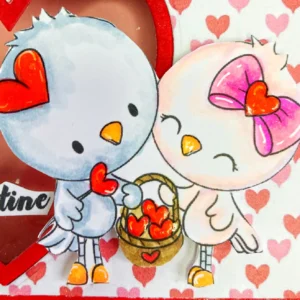Close up of the coloured digital stamp birds heart basket from Polkadoodles A close-up of the coloured digital stamp featuring two birds, decorating the front of the valentine treat box.