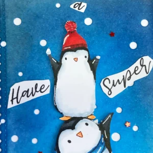 Close up of the sentiment on the top Close-up of the top section of a Penguin Birthday Card showing the sentiment 'Have a Super...' in playful cut-out letters, layered over a snowy background with die-cut snowflakes
