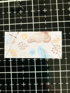 Creating the flap of the tea bag card The back of the patterned paper used for the flap of the tea bag card, showing carefully marked diagonal lines ready for cutting.