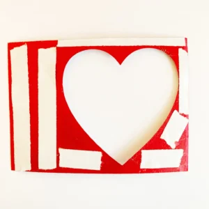 Dubble side tape around the heart window The back of the heart-shaped window with double-sided tape applied to secure the acetate in place.