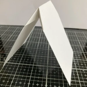 Folded card base shaped tea bag The folded tea bag-shaped card base, displaying its structure and the potential for creating a dimensional and interactive design.