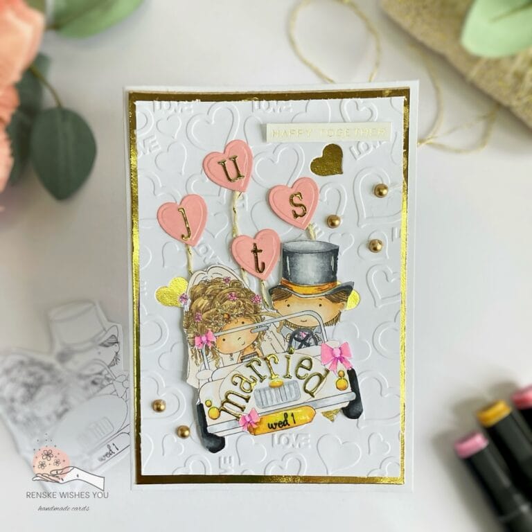 Overhead view of a handmade wedding card showcasing a wedding car design with heart-shaped balloons. The elegant gold accents and delicate details highlight the joyful theme. The card is flat, with a clear view of the design, making this wedding card tutorial easy to follow for card makers.