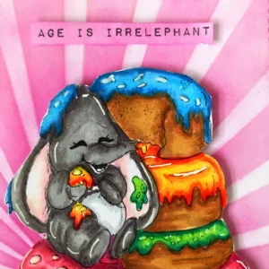 Age is Irrelephant Close-up of the top sentiment strip on the elephant birthday card, reading “Age is irrelephant,” inked in pink to match the background.