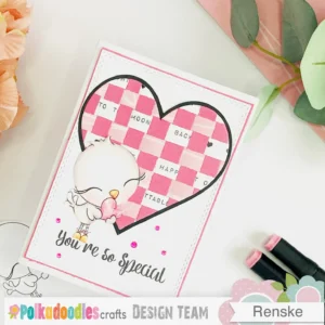 DIY Valentine's Day card A top-down angled view of the DIY Valentine's Day card, showcasing the layered design with the paper-woven heart, sentiment, and love bird digital stamp.