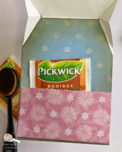 Inside of the shaped tea bag card Inside view of the shape tea bag card, showcasing the patterned paper background and a pocket perfectly sized to hold a tea bag, adding a thoughtful touch to the design.