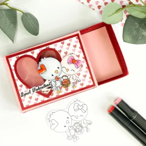 Open Slider Treat Box Polkadoodles A top-down view of the valentine treat box with the red inner box partially slid out from the pink sleeve, highlighting its functional slider design.