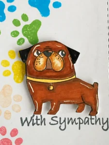 Coloured dog stamp Close-up of the stamped and coloured dog image on a handmade pet sympathy card. The warm brown tones and subtle shading bring the illustration to life, adding a heartfelt touch.