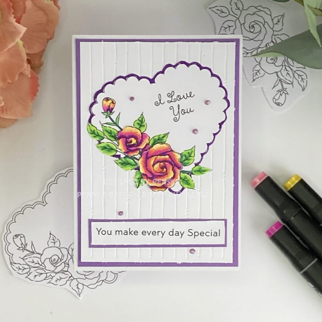A top-down view of the handmade love card. The design features a scalloped heart with detailed roses and leaves, coloured in shades of pink, purple, and green. The heart is placed on an embossed white background with a purple border. Below the heart, a sentiment reading "You make every day special" is framed with matching purple cardstock. Pearl drops embellish the design for a delicate touch.