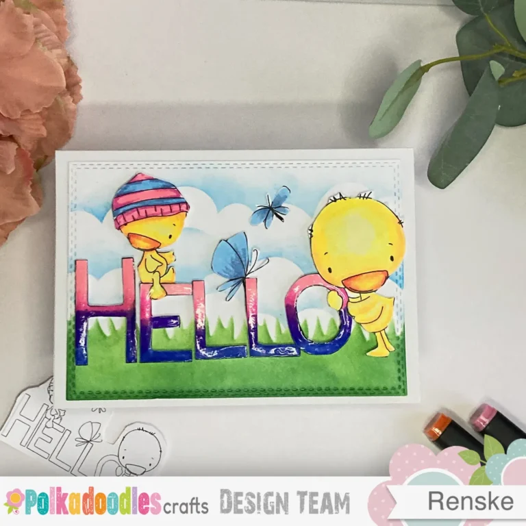 Top-down view of a handmade Hello Spring card, featuring a colourful spring-themed digital stamp. The card design includes twe ducks. One sitting on the E and one holding the O from the word Hello.