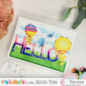Hello Spring card Polkadoodles Hello Spring card photographed from above at an angle, showcasing the layers, colours, and intricate details of the handmade design. The digital stamp Hello Spring adds a fun springtime touch, featuring two duck on the word hello and a grass and cloudy background.