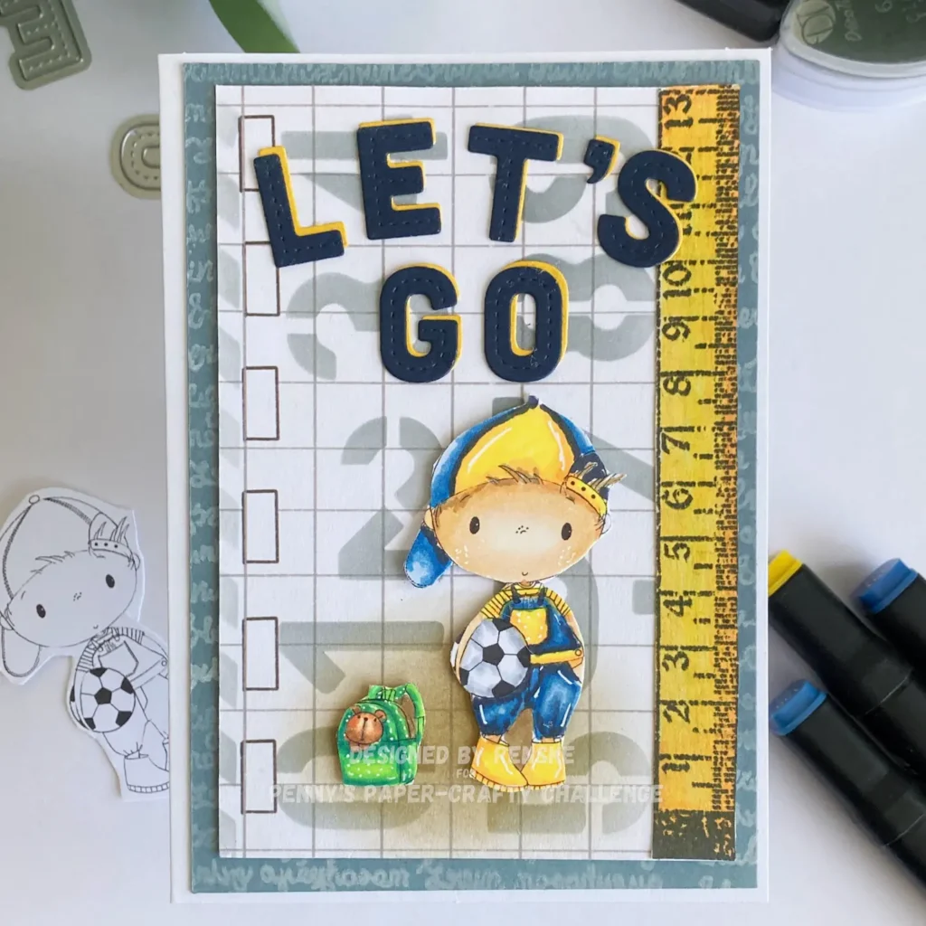Handmade card featuring the bold phrase “LET’S GO” in navy and yellow, with a cute cartoon boy holding a soccer ball—an ideal back to school card idea for sporty kids. The background includes a grid pattern and ruler design, adding a school-themed touch.