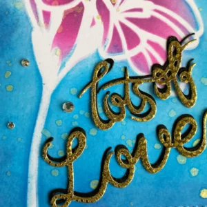 Close up sentiment Lots of Love (1) Gold foiled sentiment layered over black die-cut letters to create a bold shadow effect.
