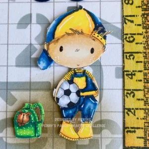 Coloured back to school boy Digitl stamp All Dressed Up Stamps Close-up of the coloured digital stamp used in this back to school card idea. The image shows a young boy in a blue overall, yellow striped shirt and a cap, holding a ball. His green school bag holds a teddy bear, and the colouring highlights facial details and shading.