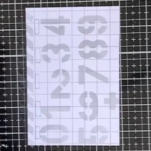 Patterned paper stenciilled with numbers Close-up of the patterned paper used in this back to school card idea. Stencilled numbers in soft grey ink add a school-themed background.