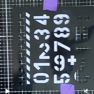 Stencil with numbers Black stencil with numbers 0 to 9, a plus sign, and diagonal stripe designs, perfect for crafting a math-inspired back to school card idea.