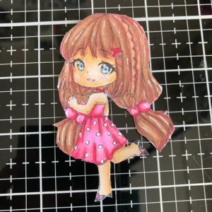 Coloured and cut digital stamp Leann's world Cut-out and coloured digital stamp for the handmade birthday card, showing a detailed girl image with warm skin tones, layered hair, and vibrant dress shades.