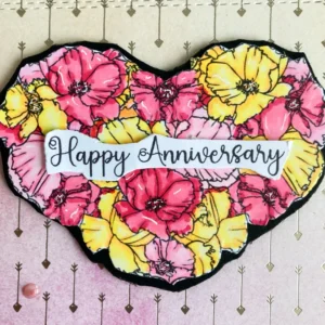 Coloured flower heart digital stamp Close-up of the floral heart digital stamp used on the handmade anniversary card. The image shows fine marker blending in shades of yellow, blush, and cherry pink. White gel pen highlights accent the petal edges and flower centres, adding depth and detail to the design.