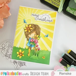 Handmade summer card with Summer Dreams Winnie Angled top-down photo of the easy handmade summer card showing depth and layering. The yellow ink-blended sunburst background shines behind the central digital stamp. The die-cut grass adds dimension at the bottom edge. The card’s clean white border frames the scene, highlighting the summery theme.