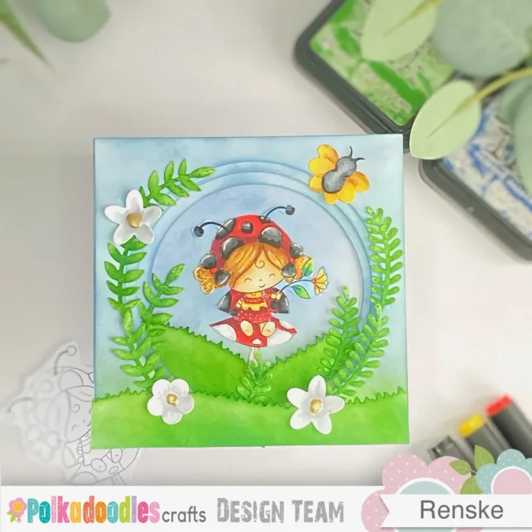 Top-down view of the completed tunnel card, shown flat with all layers aligned. You can see the full 3D scene with the ladybug digital stamp framed by ink-blended circular windows. This image highlights the finished look of the tunnel card tutorial project.