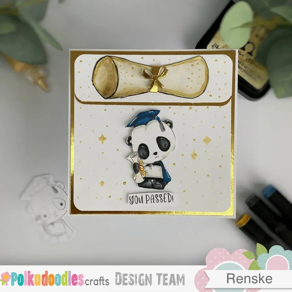 Top-down view of the DIY graduation card featuring a layered white and gold background, a hand-coloured panda digital stamp, and a handmade diploma scroll with gold details.