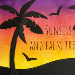 Palmtree on the left Detailed close-up of black silhouette palm tree on the left side of a handmade sunset card with yellow and purple sky.
