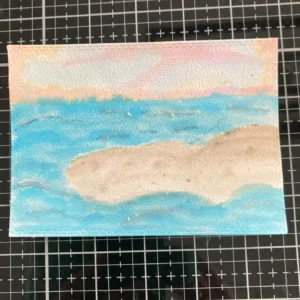 Complete background Completed watercolour background for a mermaid card, featuring a gentle sunset sky above a layered ocean and sandy bank, ready for stamping and embellishments