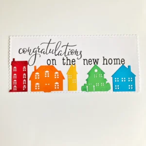Panel with houses with sentiment Slimline panel with rainbow houses glued in place and the stamped sentiment above them.