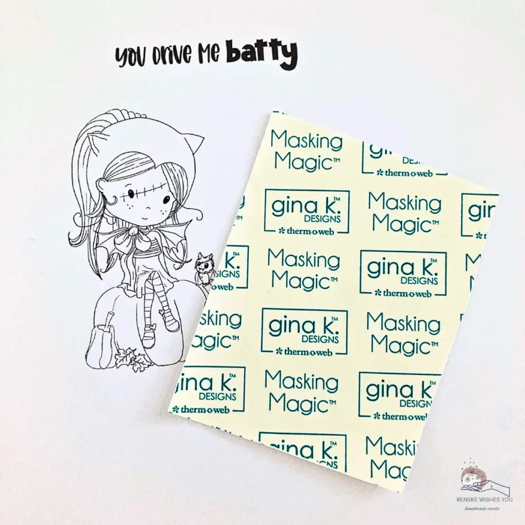 Printed digital stamp and sentiment next to masking paper flipped upside down to show size needed for masking.