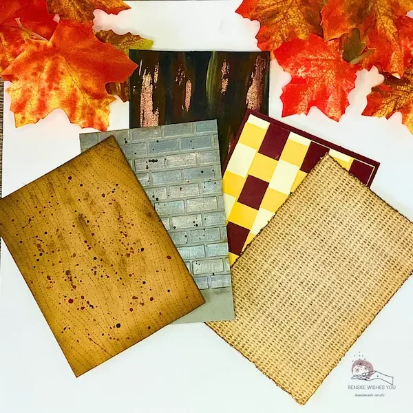 Five handmade autumn card backgrounds arranged together: woodgrain, brick wall, burlap, woven paper, and weathered metal, in warm fall colors like brown, orange, and gold.
