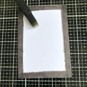 Coloured card frame created with an alcohol marker to match the autumn tones of the woodgrain background card, adding a neat finished edge.