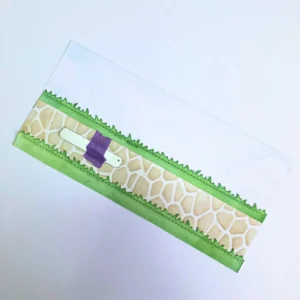 The background panel with the die taped to create a sloth for this slider card.