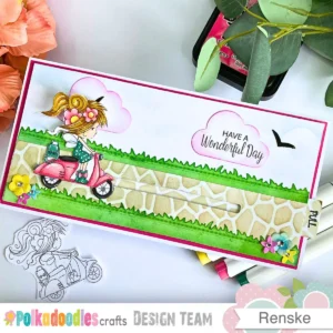The completed project for an interactive slimline card tutorial showing a fairy on a pink scooter gliding along a stone path.