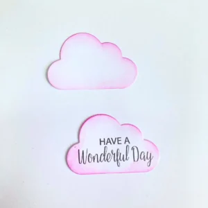 White cloud die cuts with soft pink ink blended edges and a printed sentiment for a spring card.