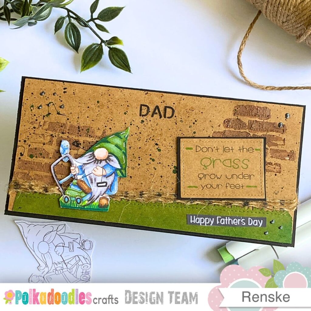 A landscape slimline card tutorial design features a Lawn Mower Gnome and a rustic brick background. The word DAD is punched into the kraft cardstock to balance the overall composition today. Black 3D pearl paint dots add a final touch of visual rhythm to the layout