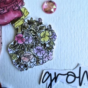 A detailed close-up shot of the small floral bouquet held by the Ruby digital stamp . The bouquet contains delicate flowers coloured in pastel pink, pale yellow, and soft purple with muted green leaves . Above the bouquet rests a faceted pink crystal gem, while a white paper strip with the word grow in black script lies below it